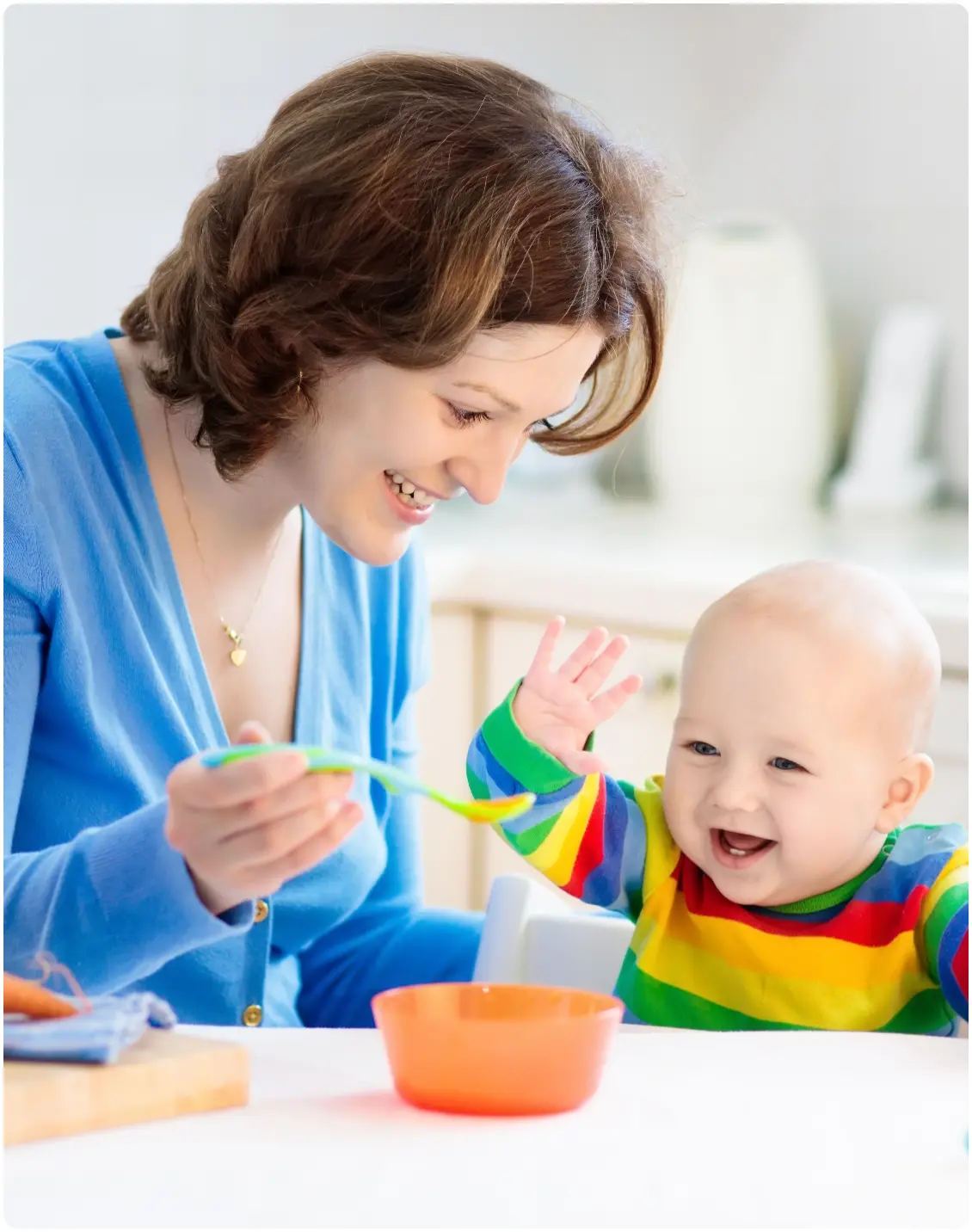 A nanny feeding a baby